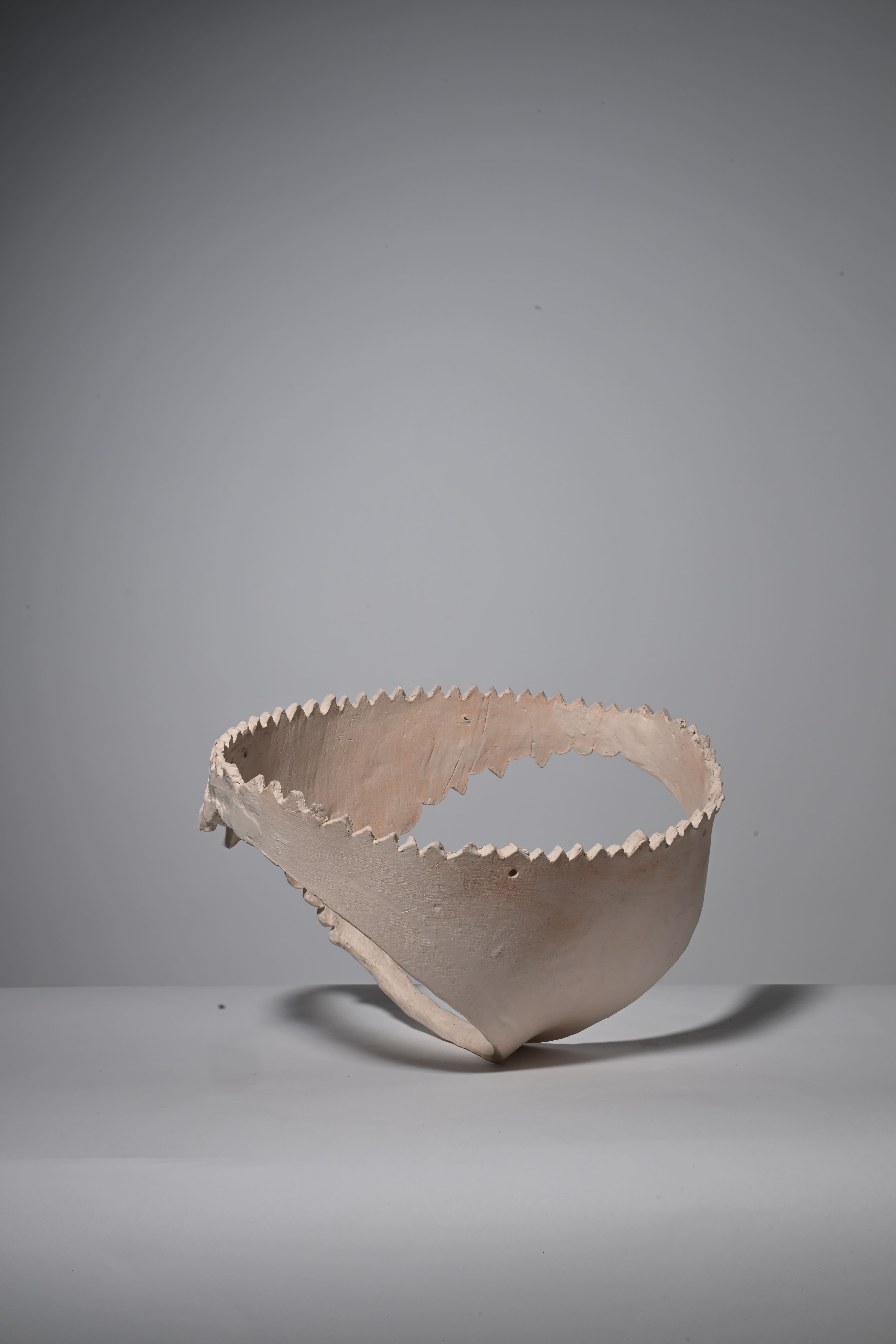 image of clay sculpture in the shape of underwear,bisque fired, back view