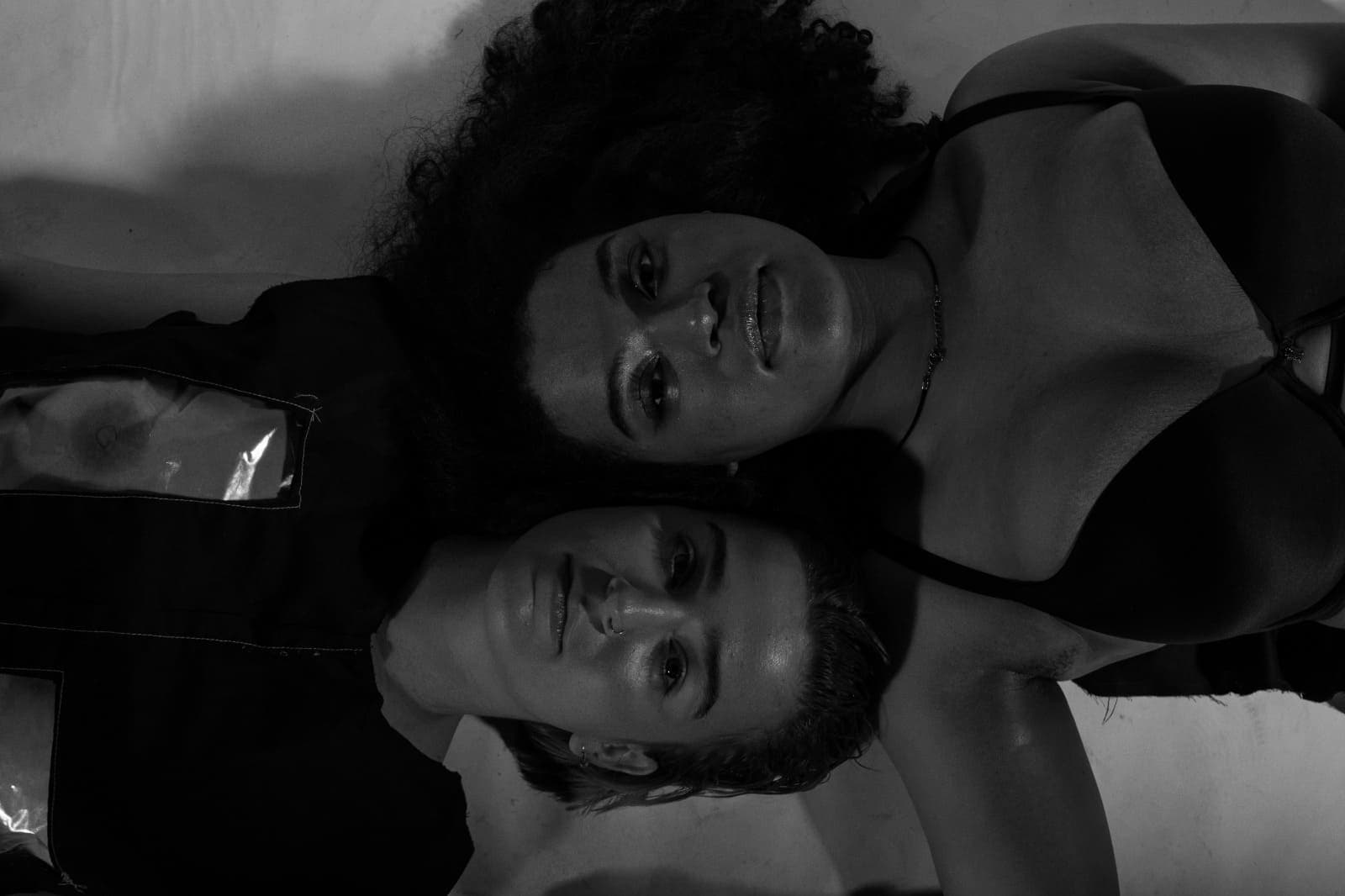 image of two women laying on the floor looking up into the camera