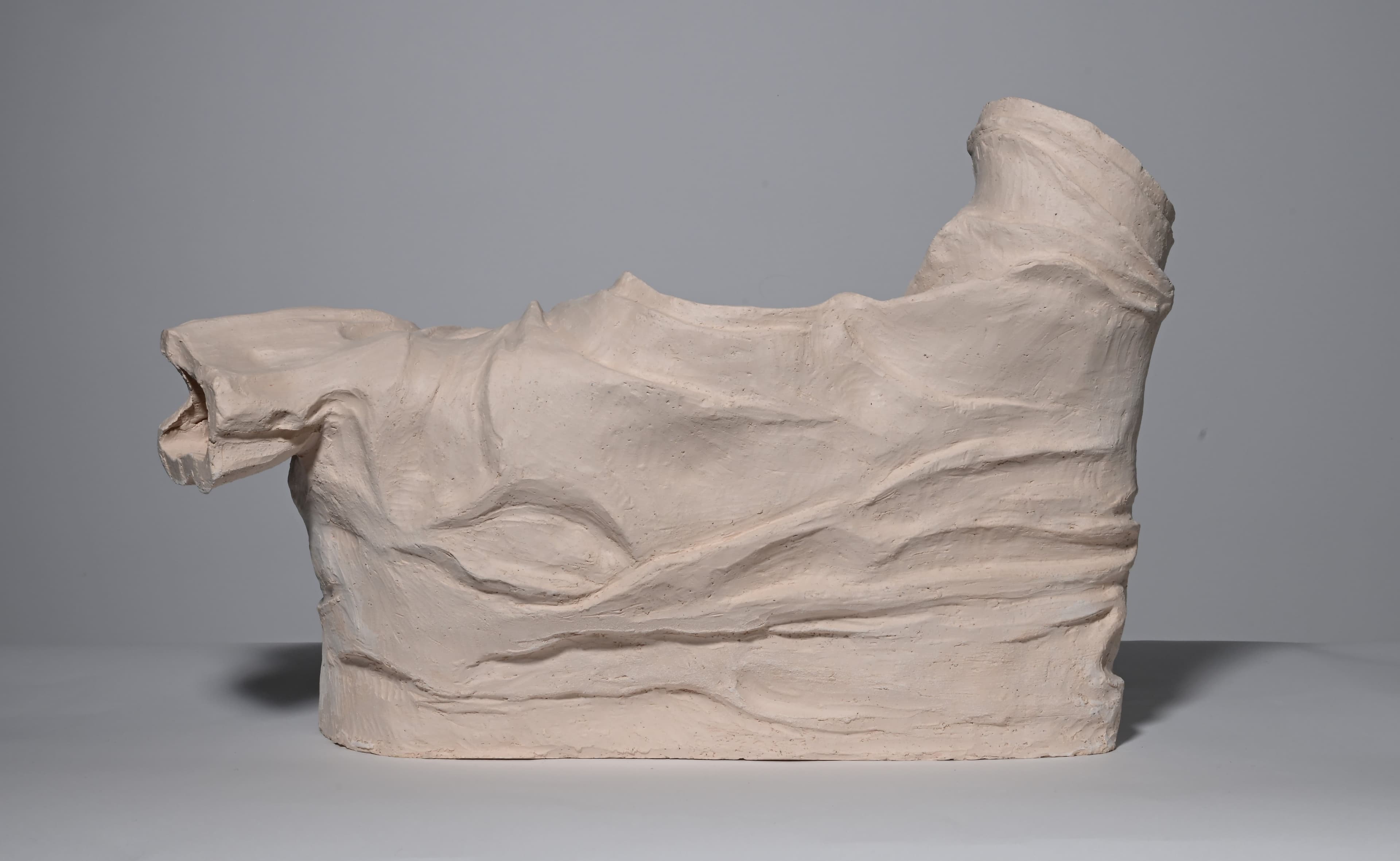 clay sculpture in the shape of wrinkled shirt, bisque fired, back view